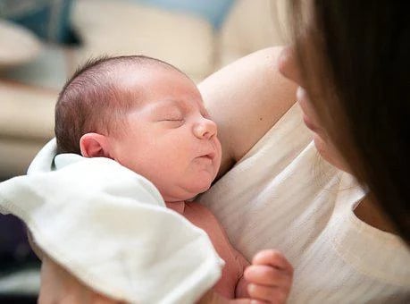 Tender Moment Between Mother And Newborn